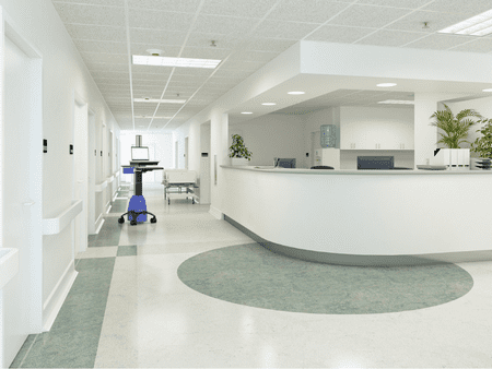 A hospital room with a large blue vacuum cleaner.