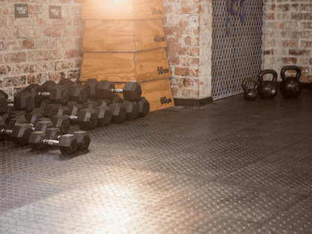 A gym with many different kinds of dumbbells.