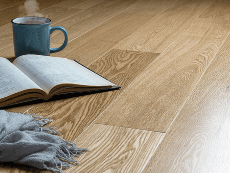 A book and coffee cup on the floor.