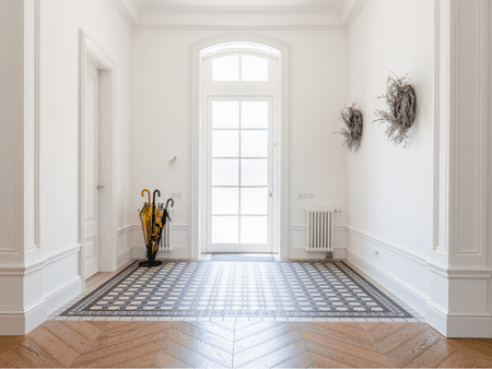 A white room with an open door and a rug.