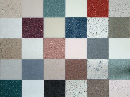 A close up of different colored tiles on the floor