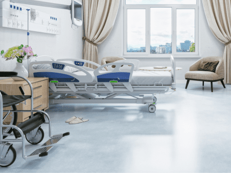 A hospital room with beds and a couch.