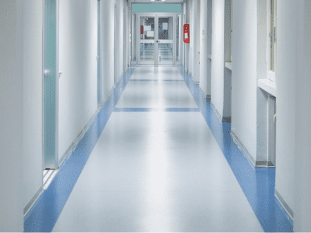 A long hallway with blue and white floors.